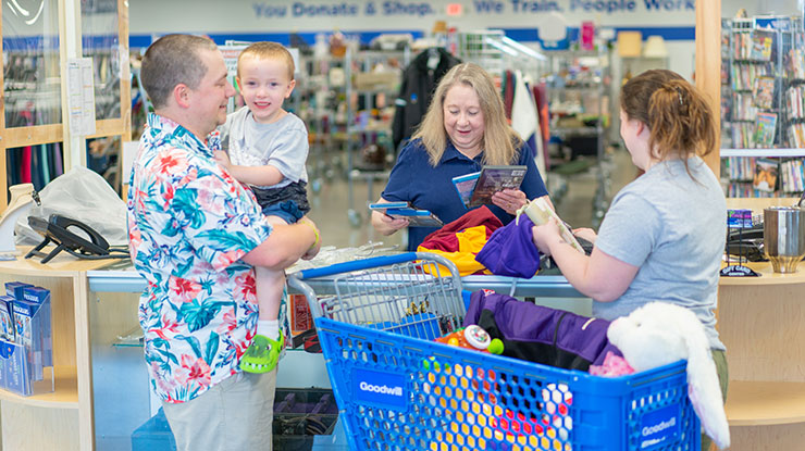 family at checkout counter at Goodwill