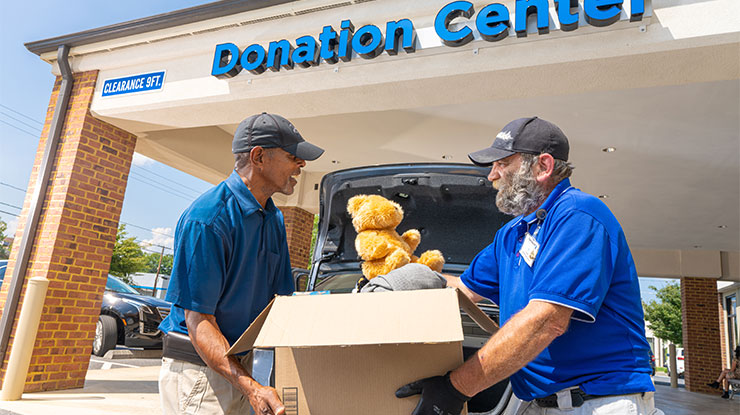 Goodwill employee taking donations from man