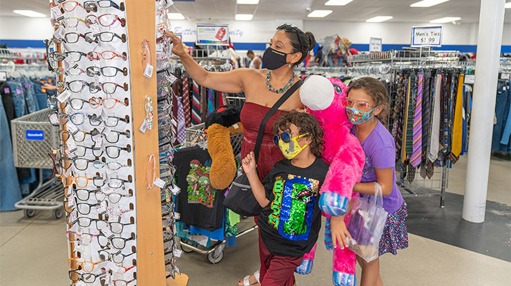 mother and 2 children shopping in a Goodwill store