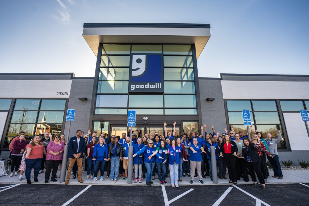 Group of people gathered outside the new store for the grand opening