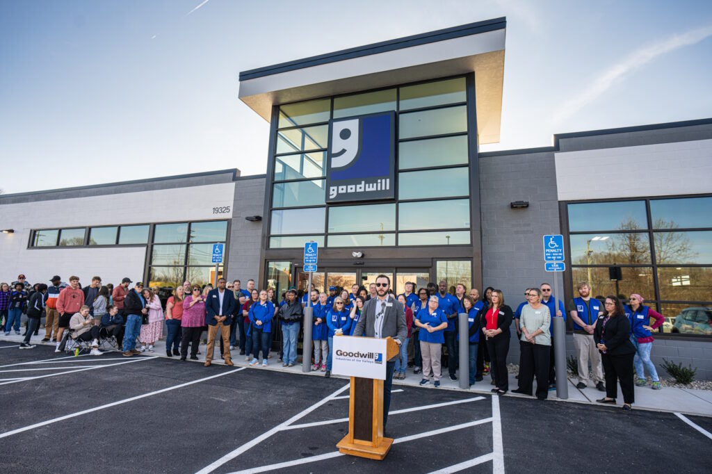 Man speaking at the podium for the grand opening.