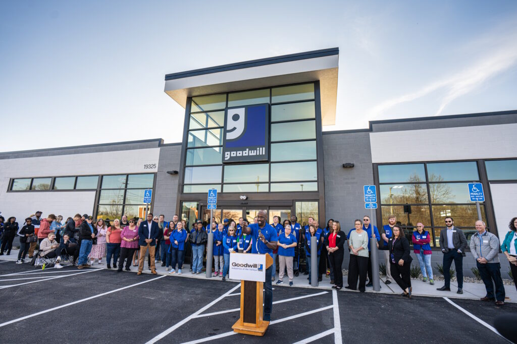 Man speaking at the podium for the grand opening.