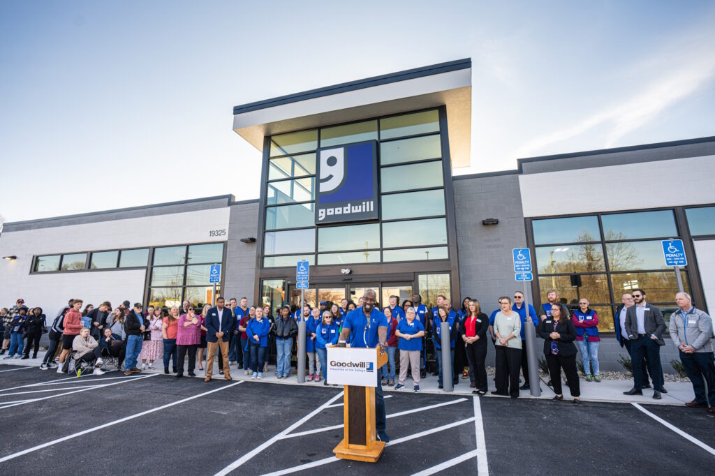 Man speaking at the podium for the grand opening.