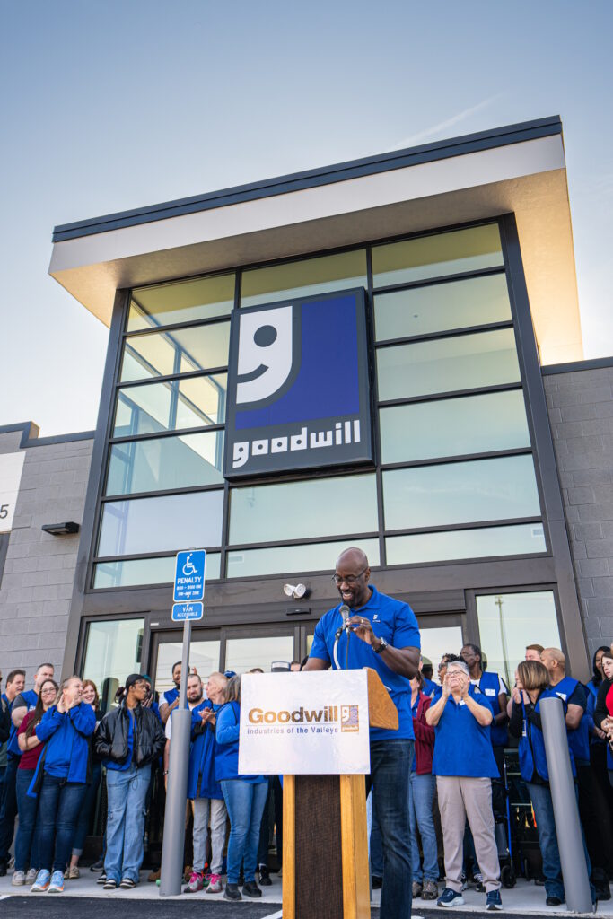 Man speaking at the podium for the grand opening.