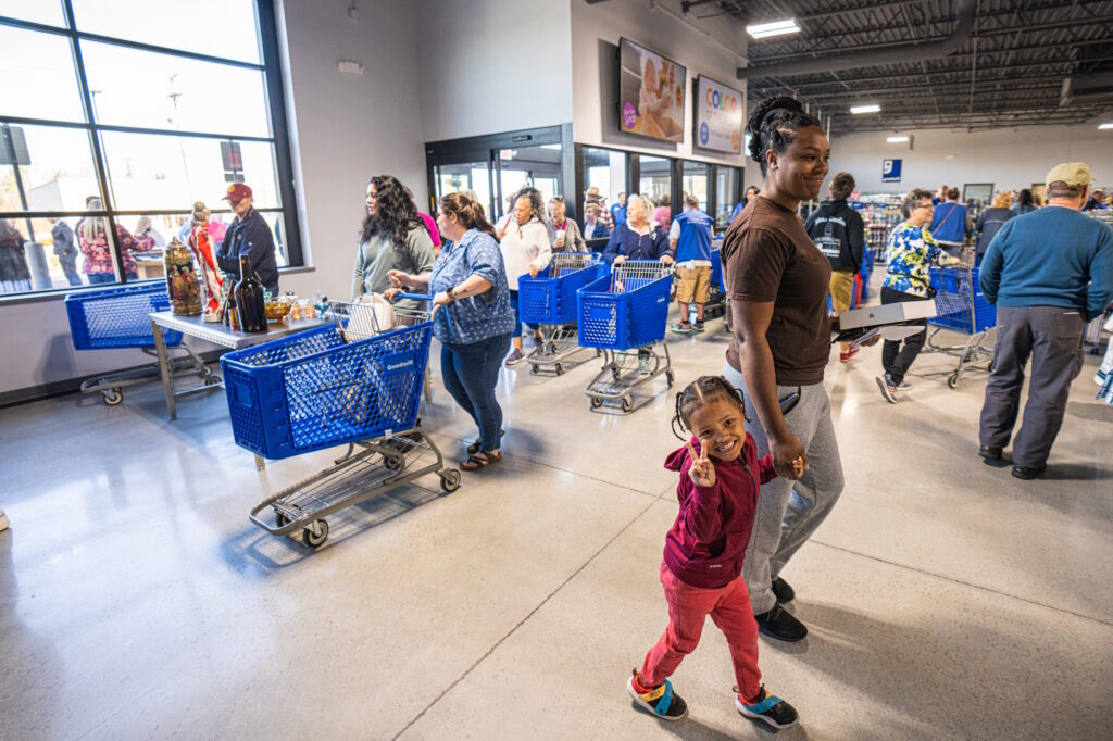 A woman leading a child in the store