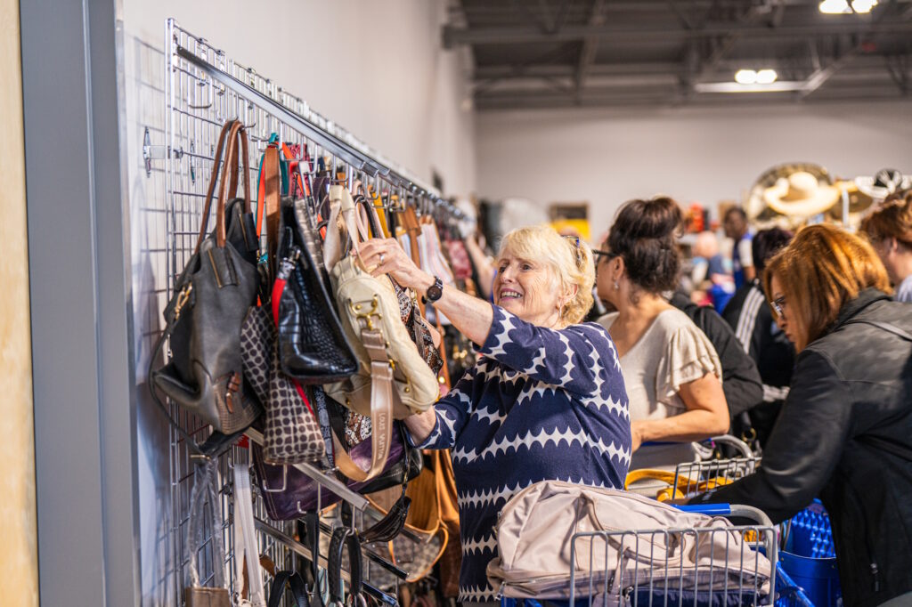 A woman looking at purses